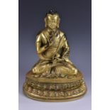 Sino-Tibetan School, a gilt bronze, of Buddha, seated in a a lotus, holding vajra and gokorei bell,