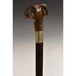 A Victorian silver-mounted softwood and malacca walking stick, the pommel carved as a boxer dog,