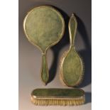 A George V silver and shagreen three piece dressing table set, comprising hand mirror,