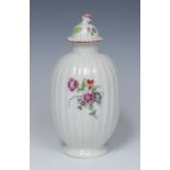 A Worcester ribbed ovoid tea canister and cover, painted with scattered flowers, domed cover,