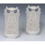 A pair of Graingers Worcester reticulated spreading ovoid vases, in the white,