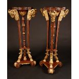 A pair of Neo-Classical style parcel gilt mahogany torcheres,