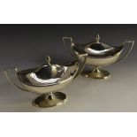 A pair of George III silver pedestal boat shaped sauce tureens, domed covers with acorn finials,