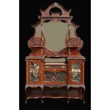 A late Victorian mahogany salon cabinet, the shaped design with bevelled plates and upstands,