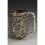 An Indian silver pint mug, profusely chased with flowers and scrolling foliage, loop handle,