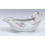 A Worcester Cos Lettuce sauce boat, curved stalk handle, decorated with flowers,
