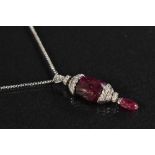 A carved ruby and diamond pendant necklace, principle carved Burmese ruby measuring 17.79mm x 12.