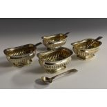 A set of four George III silver half-fluted boat shaped salts, gadrooned everted rims,