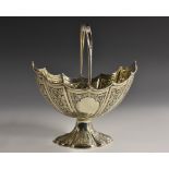 A Victorian silver batwing-fluted oval swing-handled pedestal sugar basket,