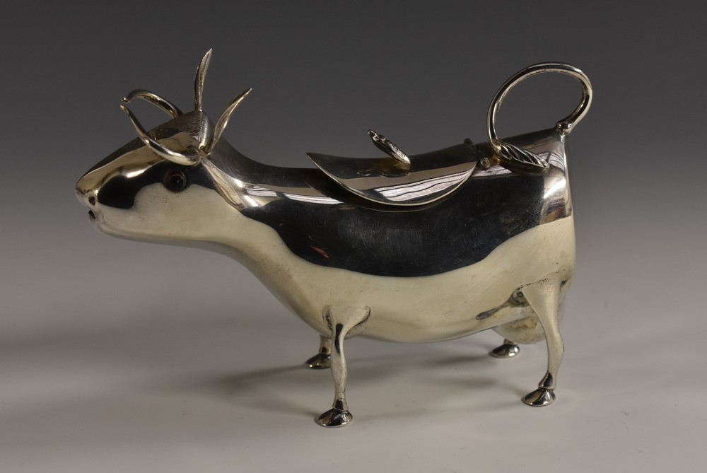 A Dutch silver cow creamer, in the manner of John Schuppe, hinged cover crested by a bee, 13.