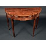 A George III mahogany demi-lune card table, folding top enclosing a baize-lined playing surface,