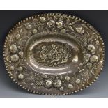 A Continental silver oval sideboard dish, chased with frolicking putti,