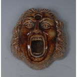 A Derbyshire brown salt glazed stoneware inkwell, as a bewigged gentleman, open mouthed, 7cm wide,
