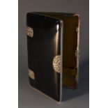 An Art Deco silver and noir enamel rounded rectangular cigarette case,