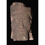 A Medieval gritstone corbel, carved as the head of an ecclesiastical dignitary, 27cm high,