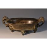 A Chinese patinated bronze oval censer, cast in the archaic manner, mythical beasts twin-handles,