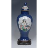 A Chinese baluster vase and cover, painted in polychrome with birds amongst branches and flowers,