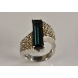 A tourmaline and diamond cluster ring, central baguette green blue tourmaline, approx 4.