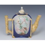 A Victorian Majolica teapot, in relief with bird and butterfly on blossoming branches,