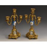 A pair of Louis XVI Revival ormolu and porcelain three-branch candelabra,