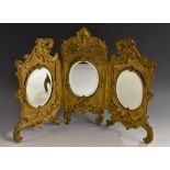 A 19th century Rococo Revival gilt metal triptych dressing table mirror,