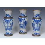 A three-piece garniture of Chinese crackle glaze stoneware inverted baluster vases,