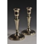 A pair of Elizabeth II silver candlesticks, urnular sconces, tapered columns,