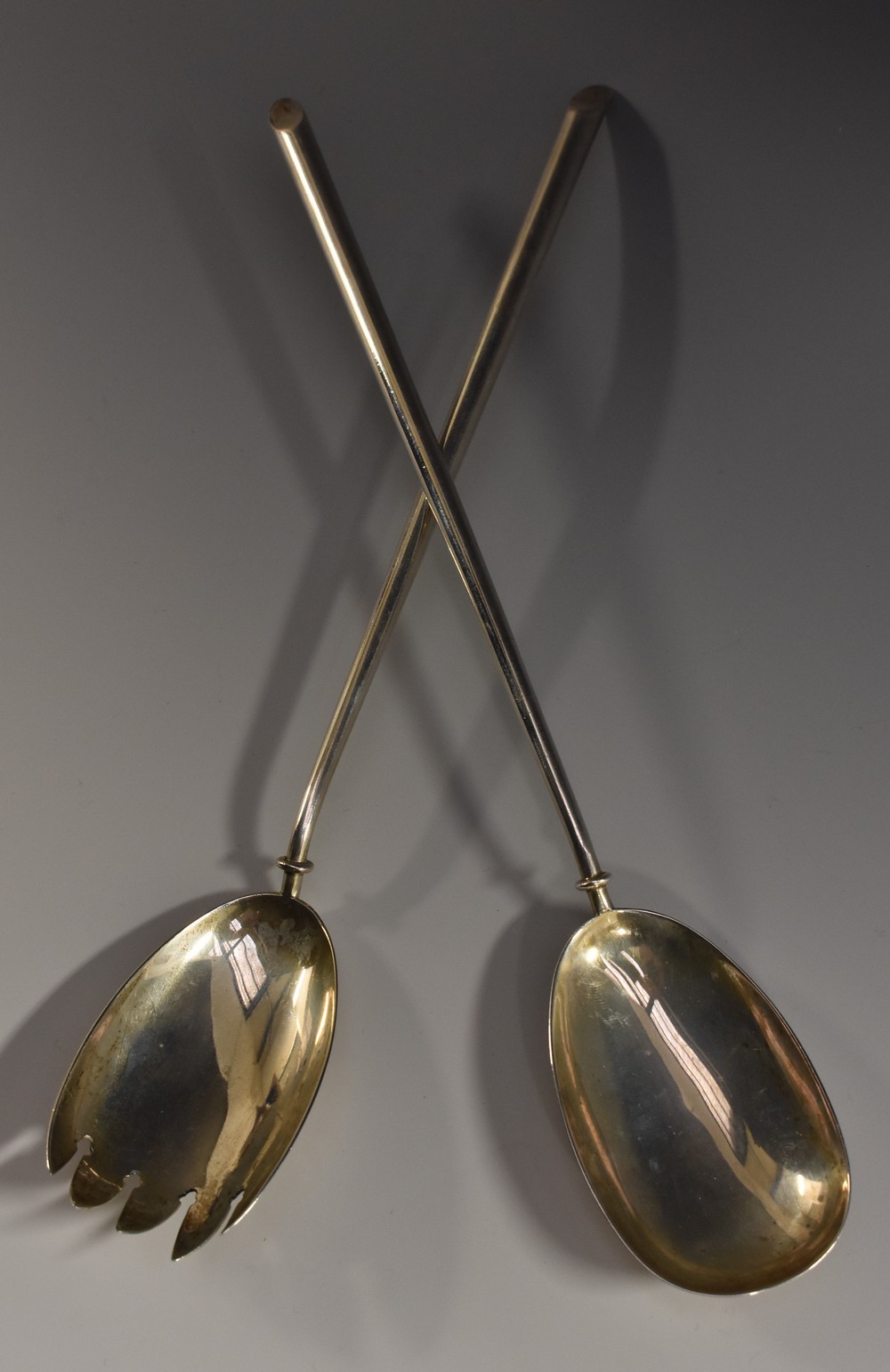 A pair of late Victorian silver slip top salad servers, quite plain, 30cm long,