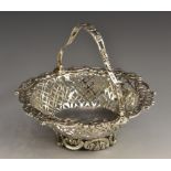 A late Victorian silver shaped circular swing-handled sweetmeat basket,