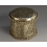 A Dutch silver circular box and cover, chased with figures in 18th century dress,