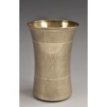 An Arts and Craft silver coloured waisted cylindrical beaker, engraved with bands, 9.75cm high, 2.