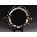 A South American silver coloured metal shaped circular bowl or pan, punch-beaded border,