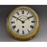 A Prescot Clock Company circular brass marine timepiece, enamel dial, Roman numerals,