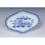 A Caughley shaped oval dish, moulded rim, painted with a chinoiserie scene in underglaze blue,