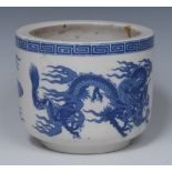 A Chinese circular jardiniere, printed in underglaze blue with a dragons chasing a flaming pearl,