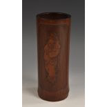 A Chinese bamboo bitong brush pot, carved in relief with an immortal standing on a turtle,