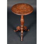 A Black Forest tripod occasional table, the circular top incise-carved with flowering leafy stems,