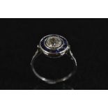 A diamond and sapphire cluster ring, central round brilliant cut diamond approx 0.