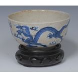 A Chinese bowl, painted on tones of blue with dragons chasing a flaming pearl,