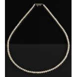 A slightly graduated single strand cultured pearl necklace, white metal barrel clasp, 43cm long, 10.