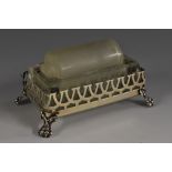 A George V silver stamp roller, clear and frosted glass mechanism, pierced border, lion paw feet,