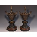 A pair of 19th century bronze and marble two handled mantel urns and covers,