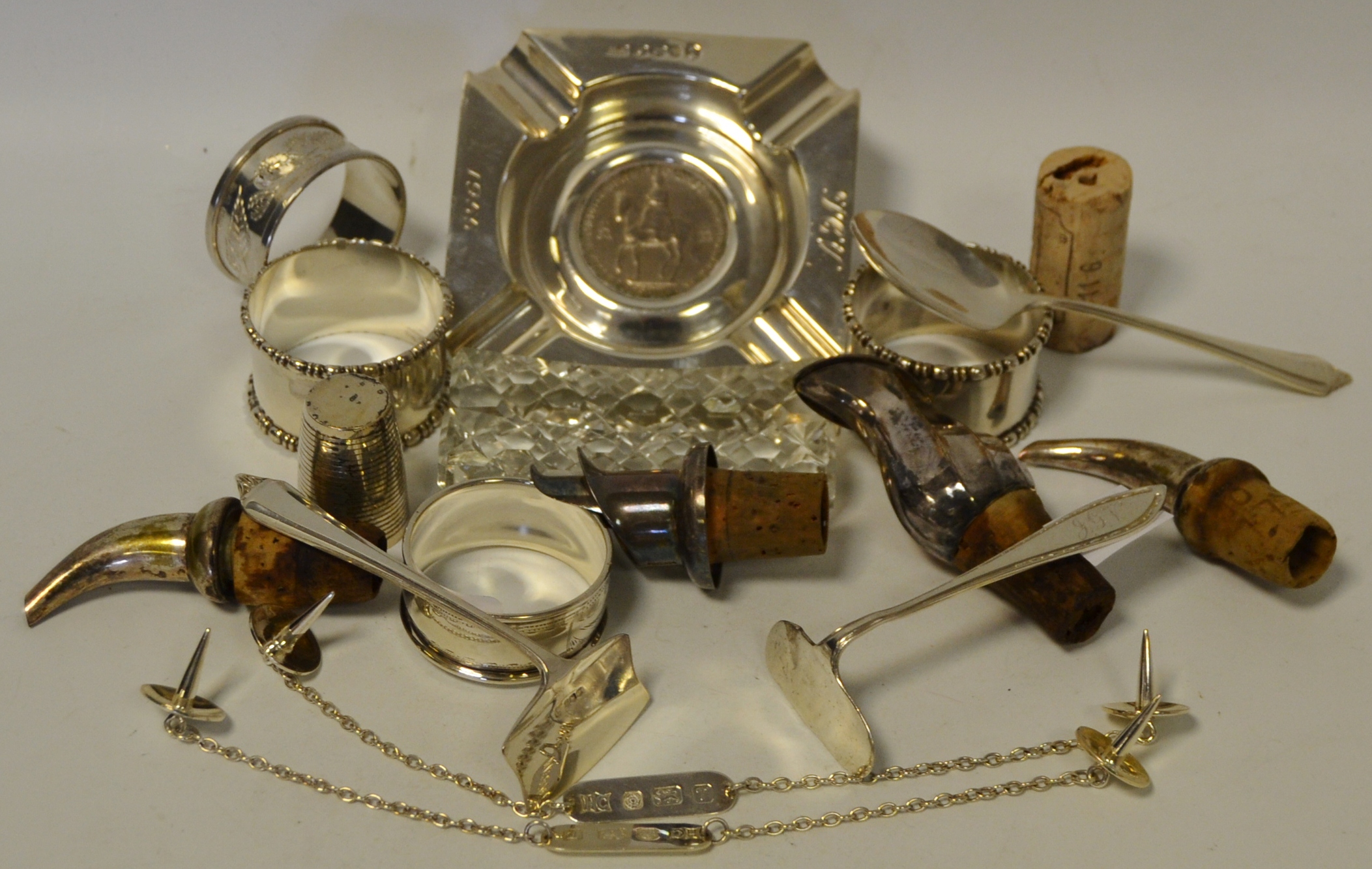 A silver ashtray inset with a 5 shilling,