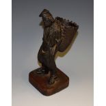 A 19th century French dark patinated bronze table vesta or spill holder, as a grape picker,