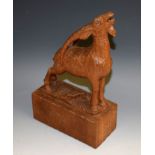 A Black Forest type carving, of a goat on a rocky outcrop, rectangular base,