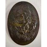 A 19th century dark patinated bronze oval plaque, cast in relief with love birds and Cupid's quiver,