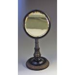 A 19th century Ceylonese ebony adjustable shaving mirror, circular bevelled plate,