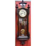 A walnut Vienna wallclock, enamelled dial, Roman numerals, subsidiary seconds, two weights.