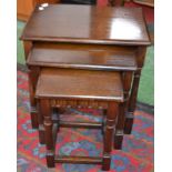 A Priory style oak nest of three tables