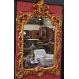 A large 20th century Rococo style ornate gilt framed mirror,